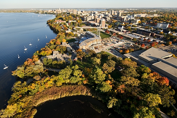 Lakeshore Residence Hall, a new lakeshore residential facility currently under construction, is pictured at center of an aerial view of the University of Wisconsin-Madison campus during an autumn sunset on Oct. 5, 2011. In the foreground left to right are Lake Mendota, University Bay and the Gymnasium-Natatorium. On the horizon is the downtown Madison isthmus and Wisconsin State Capitol. The photograph was made from a helicopter looking east. (Photo by Jeff Miller/UW-Madison)