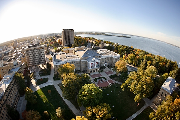 Bascom Hall atop Bascom Hill is pictured in a fisheye-lens aerial view of the University of Wisconsin-Madison campus during an autumn sunset on Oct. 5, 2011. Other majority campus facilities include, clockwise from lower left, Birge Hall, Van Vleck Hall, and Van Hise Hall. In the background at right is Lake Mendota and Picnic Point. The photograph was made from a helicopter looking west. (Photo by Jeff Miller/UW-Madison)